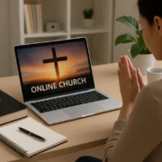 Online worship service at home with a laptop showing a cross and the words “Online Church,” with Bible and notebook on the desk.